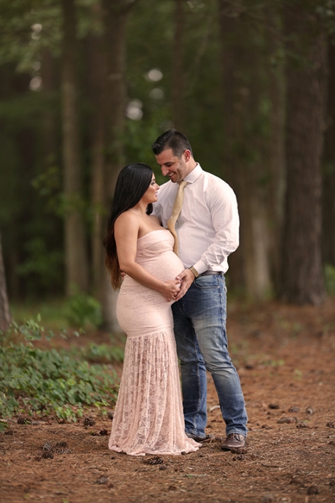 A couple having fun on their maternity shoot. A candid moment showing a lot of love