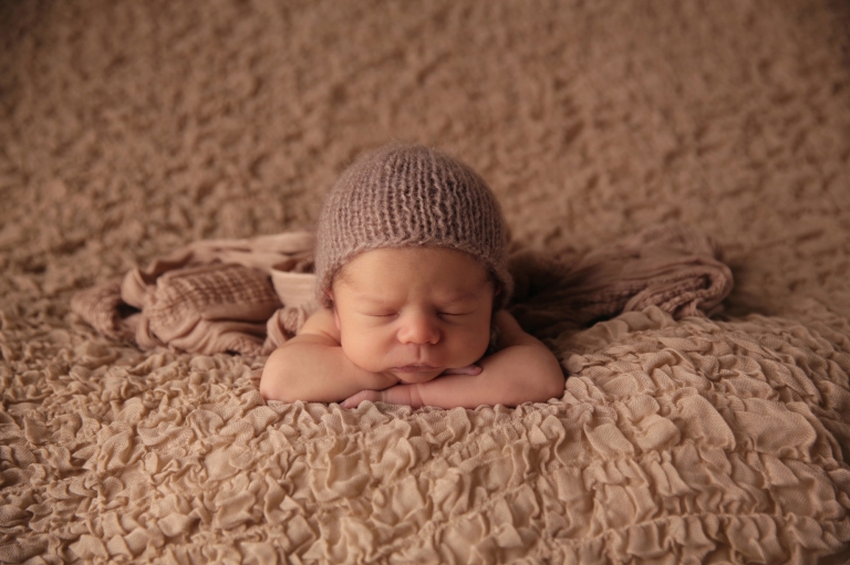 Holly Springs newborn photographer | baby boy with head on hands pose