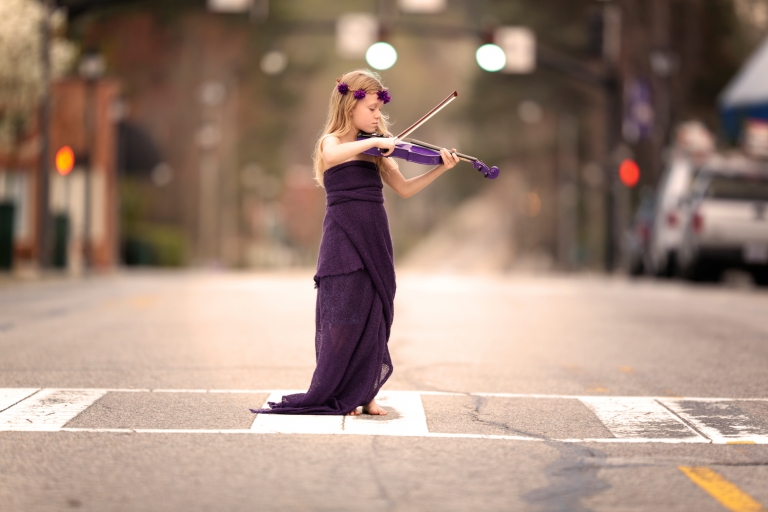 Raleigh Child Photographer - child playing violin in the street