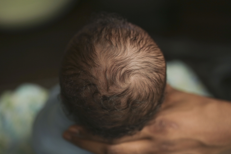 beautiful newborn head of curly hair macro shot