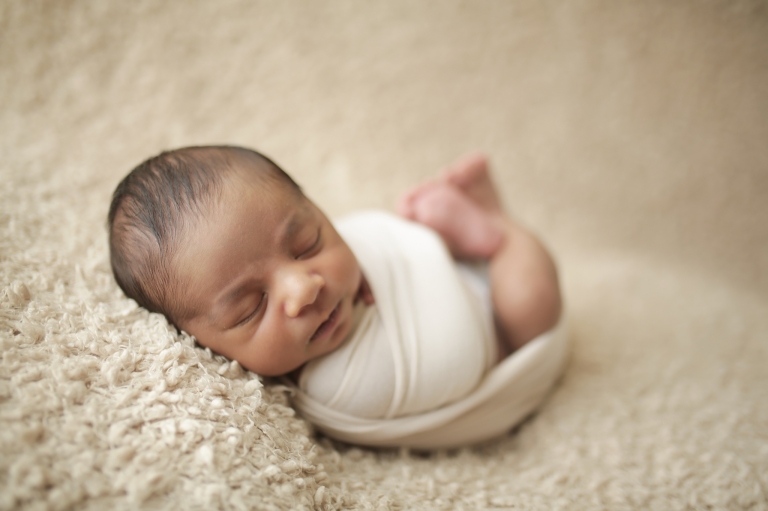 beautifully wrapped newborn in a snug tight swaddle