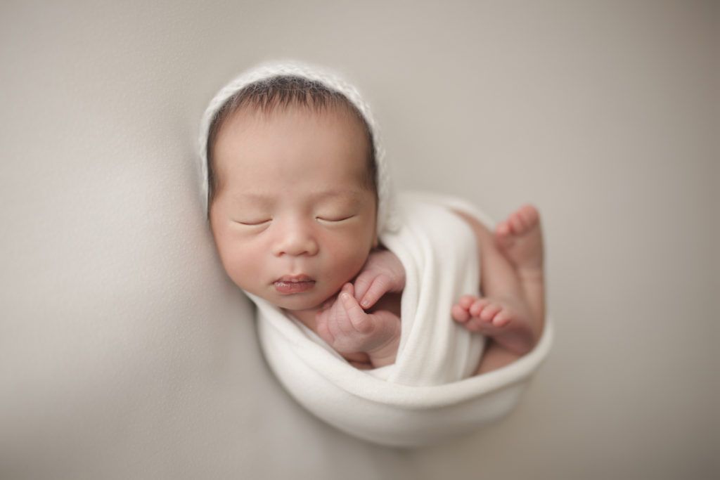 wrapped sleeping newborn baby photographed by Raleigh newborn photographer Nicola Lane