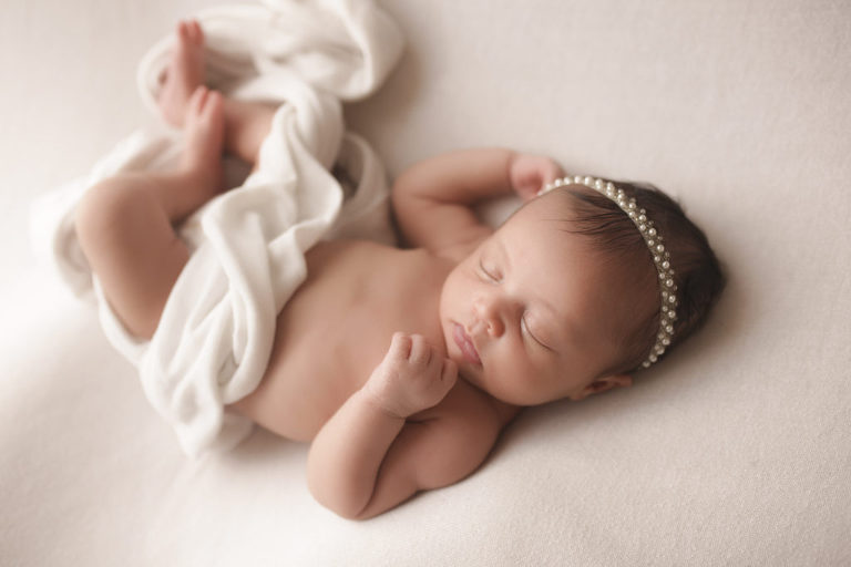 newborn baby on white backdrop